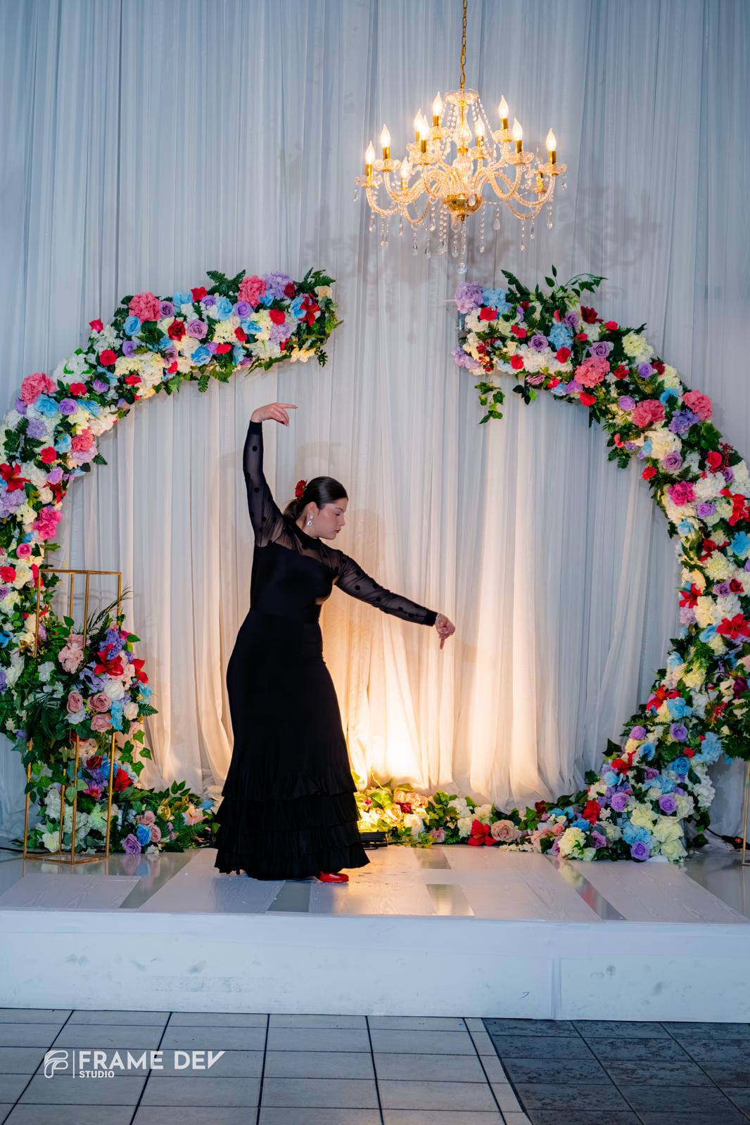 Mia dancing under floral arch